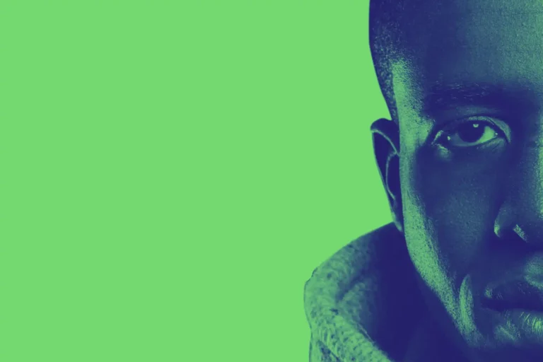 a close up of Michael O. with a green background