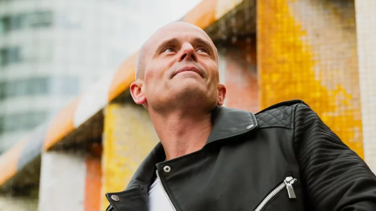 ManfroP rocking a leather jacket in an urban setting, embodying the cool and edgy vibe of his music.