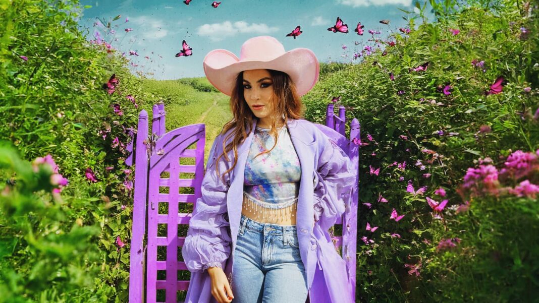 MICALL in a vibrant countryside garden, surrounded by lush greenery and fluttering pink butterflies, near a bright purple gate under a partly cloudy sky.