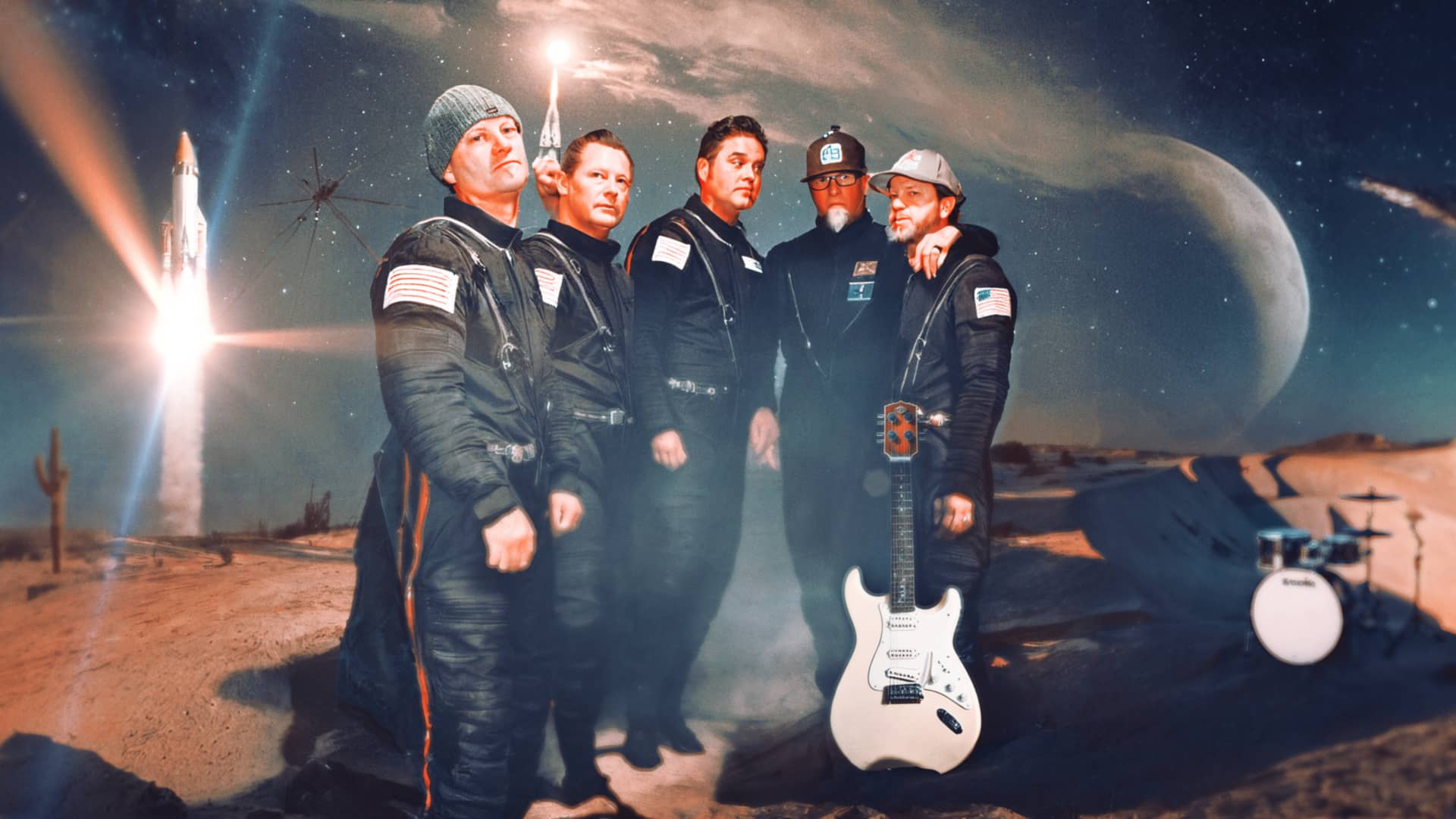 Band members in astronaut gear in desert with rocket and moon.